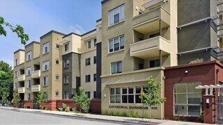 Cathedral Gardens Apartments, EAH Housing – Modern multi-story apartment building with balconies, large windows, and a street-facing entrance.
