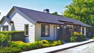 Margaret Duncan Greene features a single story affordable housing community by EAH Housing with cottage style design, pitched rooflines, and surrounding greenery.