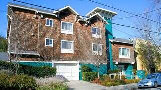 Lincoln Avenue features a three story affordable housing community by EAH Housing with shingle style exterior, bay windows, and landscaped frontage along a residential street