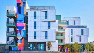 Lexington Gardens features a four story affordable housing community by EAH Housing with contemporary design, rooftop terraces, and street level landscaping in an urban neighborhood