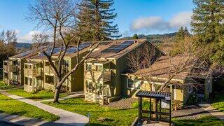 Kings Valley features a two story affordable housing community by EAH Housing with light siding, balconies, and landscaped greenery in a suburban neighborhood
