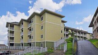 Imi Ikena Apartments features a three story affordable housing community by EAH Housing with modern design, balconies, and landscaped courtyard in a residential setting