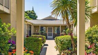 Golden Oak Manor features a two story affordable housing community by EAH Housing with beige siding, shaded walkways, and landscaped grounds in a residential setting