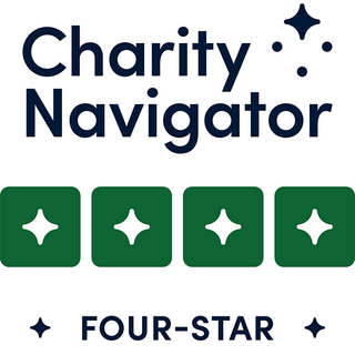 A logo featuring "Charity Navigator" in bold text, accompanied by four green stars, indicating a four-star rating for charities.
