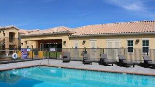 Avena Bella exterior highlighting a modern affordable housing community with warm-toned facade and inviting entryways.