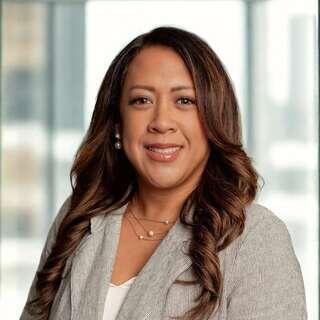 Leslie Dabi, Vice President of Information Technology Operations at EAH Housing, smiling in a gray blazer.