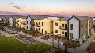 Greenfield Commons features a contemporary affordable housing community by EAH Housing with multi story buildings, balconies, and landscaped pathways in a quiet neighborhood