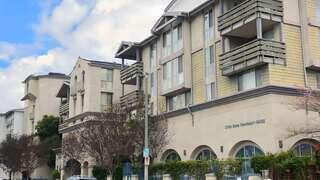 Casa Shalom Apartments, EAH Housing – Three-story residential building with balconies and ground-floor community space, featuring modern architecture and landscaped surroundings.