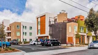 Firestone Phoenix features a modern affordable housing community by EAH Housing with colorful exterior panels and an urban setting
