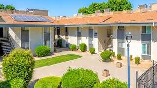 Fountain West offers affordable housing by EAH Housing with a landscaped courtyard and solar panels on the roof