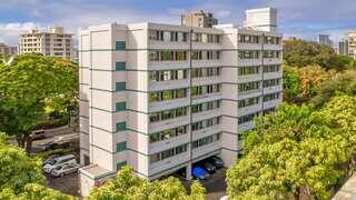 Wilder Vista features an affordable housing community by EAH Housing with a mid-rise building, mature trees, and a peaceful residential setting surrounded by greenery.