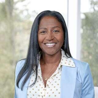 Stacey Smith-Shelley, Vice President of Real Estate Management at EAH Housing, smiling in a light blue blazer.
