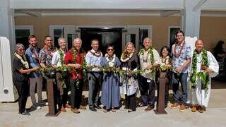 Community leaders and partners gather for a traditional maile lei ceremony outside a newly opened EAH Housing community, celebrating affordable housing and partnership in Hawaiʻi.