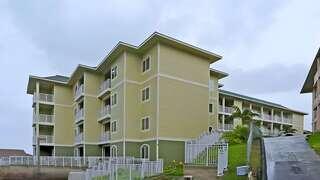 Imi Ikena Apartments features a three story affordable housing community by EAH Housing with modern design, balconies, and landscaped courtyard in a residential setting