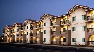 Imperial Village features a mid rise affordable housing community by EAH Housing with a simple exterior, street frontage, and urban surroundings