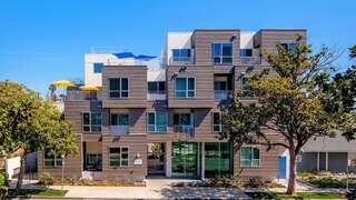 Magnolia Villas features a multi story affordable housing community by EAH Housing with contemporary design, private balconies, rooftop deck, and outdoor seating areas.