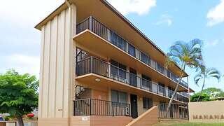Manana Gardens features a three story affordable housing community by EAH Housing with garden style layout, open air walkways, balconies, and tropical landscaping.