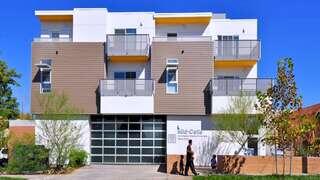 Mid-Celis Apartments features a multi story affordable housing community by EAH Housing with modern exterior, private balconies, and street level entry.