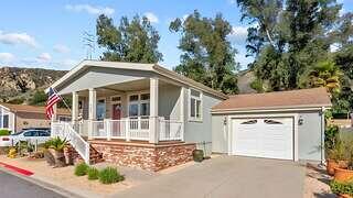 Oakridge Family features an affordable housing community managed by EAH Housing with single story homes, front porches, and desert landscaping set against rolling hills in a residential neighborhood.