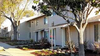 Park Place features an affordable housing community by EAH Housing with townhouse style homes, tree lined walkways, and landscaped grounds in a residential neighborhood.