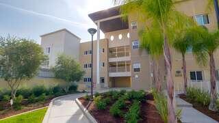 Osbourne Place features an affordable housing community managed by EAH Housing with contemporary design, landscaped pathways, and shaded outdoor spaces in a residential setting.